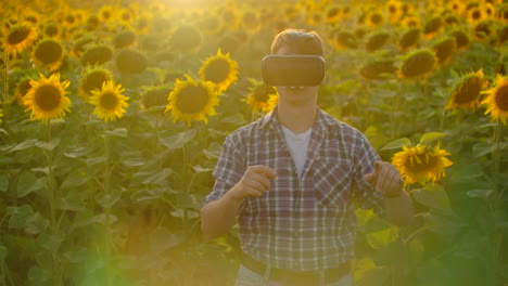 A-progressive-modern-farmer-in-a-field-with-sunflowers-uses-VR-technology.-Simulating-the-application's-user-interface.-Control-the-irrigation-system-with-drones.-Inspect-the-field-using-drones.